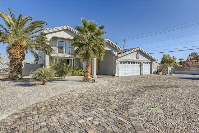 view of front of home featuring a balcony and a garage