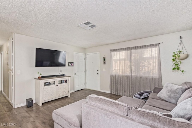 living room with hardwood / wood-style floors and a textured ceiling