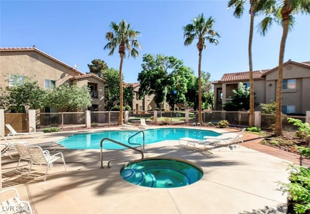 view of pool featuring a community hot tub and a patio area