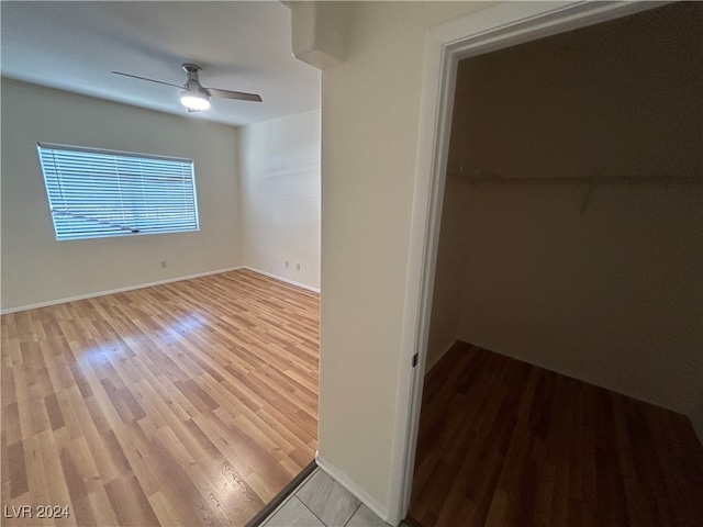 interior space with ceiling fan, light wood-type flooring, and a closet