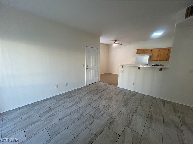 unfurnished living room featuring ceiling fan