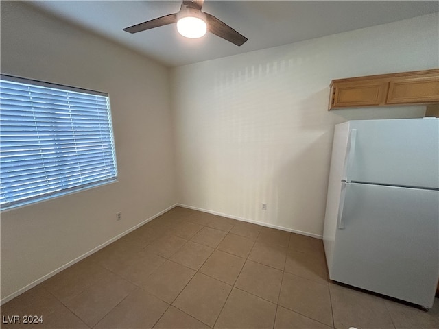 kitchen with ceiling fan, white refrigerator, and light tile patterned floors