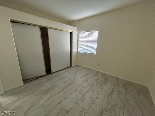 unfurnished bedroom featuring a closet