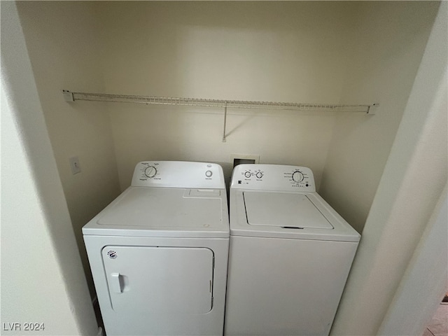 clothes washing area with washer and clothes dryer