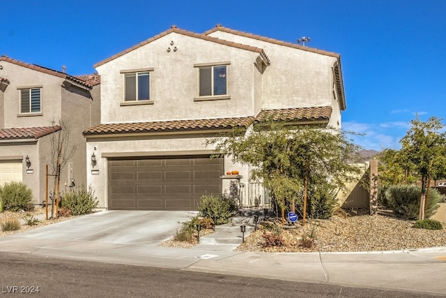 mediterranean / spanish-style home with a garage