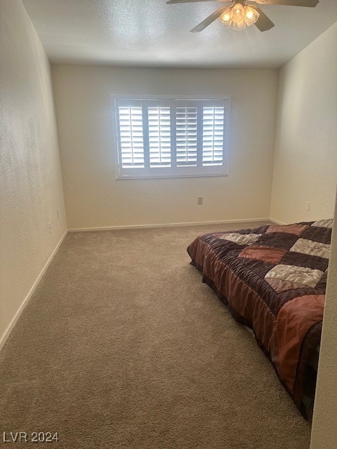 bedroom with ceiling fan and carpet