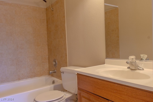 full bathroom with vanity, toilet, and tiled shower / bath