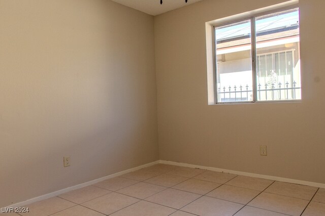 tiled spare room with a wealth of natural light