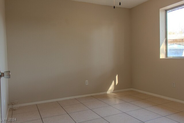 spare room featuring light tile patterned floors