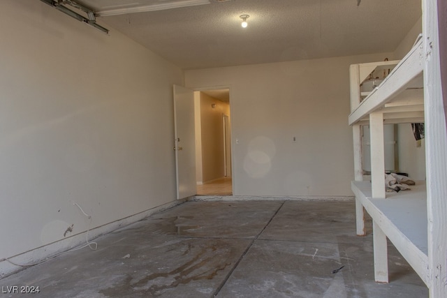 spare room featuring concrete flooring and a textured ceiling