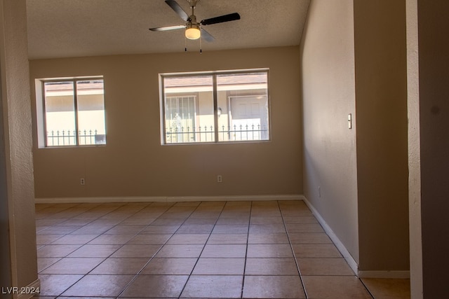 unfurnished room with light tile patterned floors, a textured ceiling, and ceiling fan