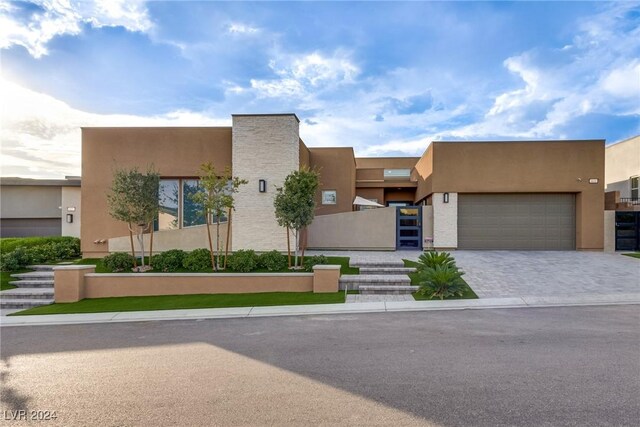 pueblo-style house featuring a garage