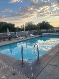 1303 Darlene Way Unit 405B, Boulder City, NV 89005 - pool at dusk with a community pool and a patio