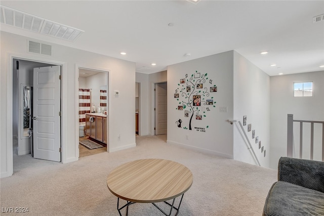 sitting room with light colored carpet