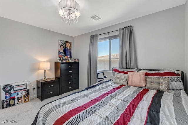 carpeted bedroom with an inviting chandelier