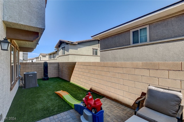 view of yard featuring a patio and central air condition unit