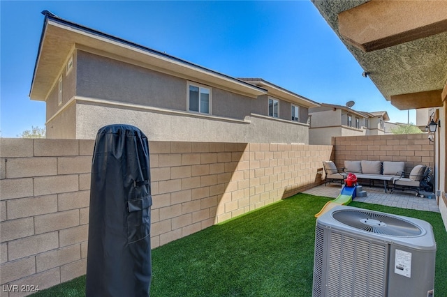 view of yard with an outdoor living space, a patio area, and central air condition unit