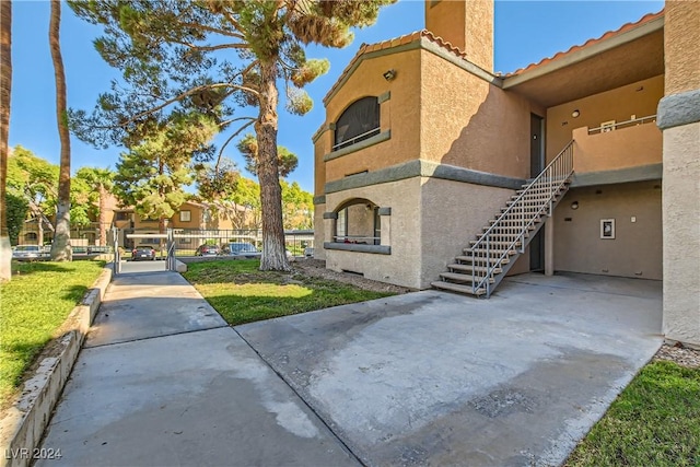 exterior space with fence and stairs
