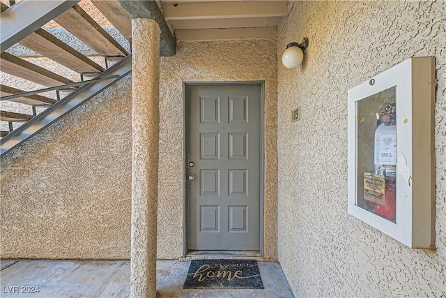 doorway to property with stucco siding