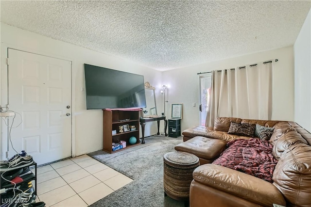 carpeted living area with a textured ceiling and tile patterned flooring