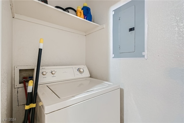 clothes washing area with electric panel and washer / dryer