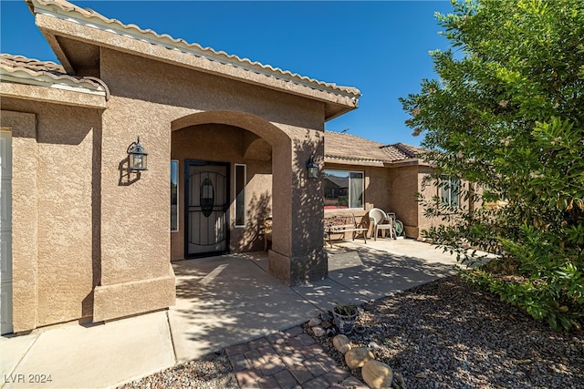 entrance to property with a patio