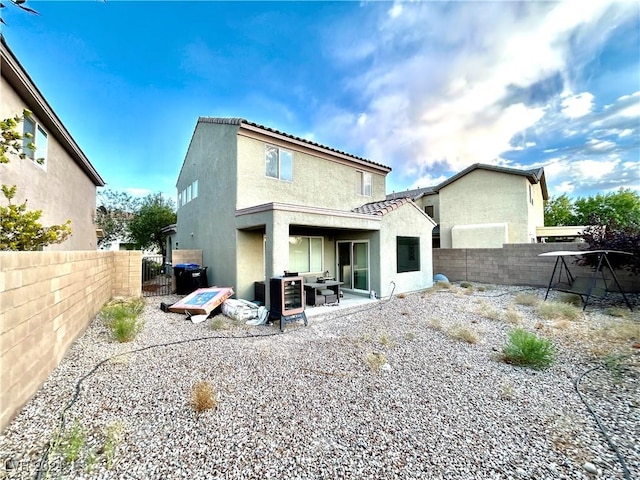 back of property with a patio