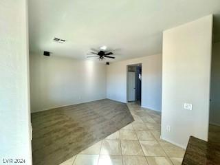 unfurnished room with light tile patterned floors and ceiling fan