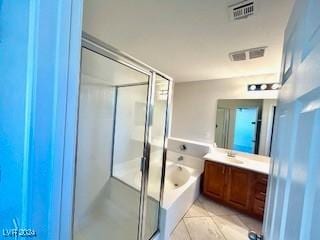 bathroom with tile patterned floors, vanity, and separate shower and tub