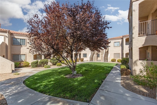 view of home's community with a lawn