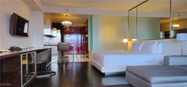 bedroom featuring sink and dark wood-type flooring