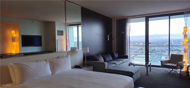 carpeted bedroom with a mountain view and multiple windows