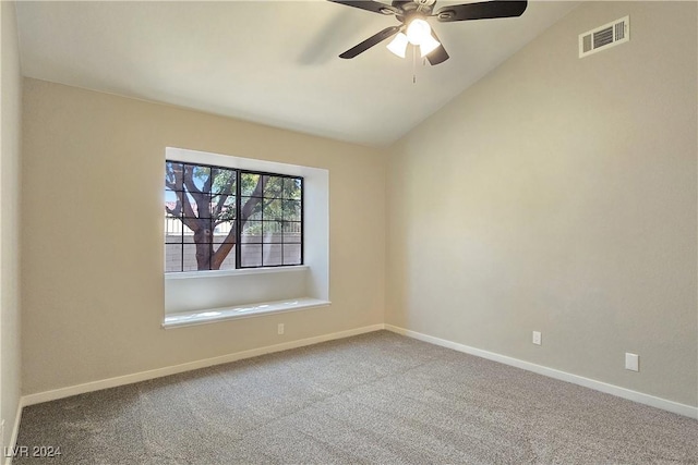 carpeted empty room with vaulted ceiling and ceiling fan