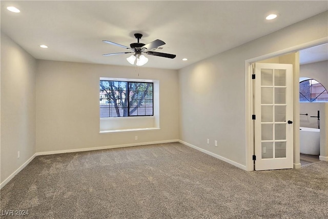 carpeted empty room featuring ceiling fan