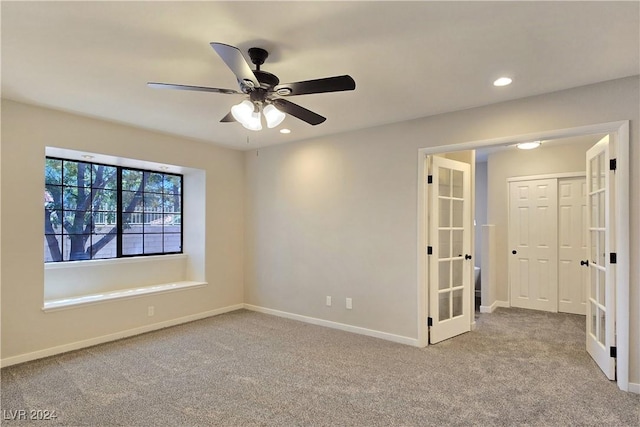 unfurnished room with light colored carpet, ceiling fan, and french doors