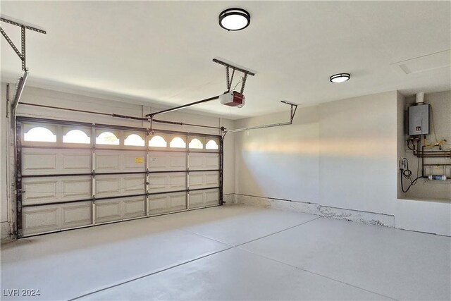 garage featuring a garage door opener and water heater