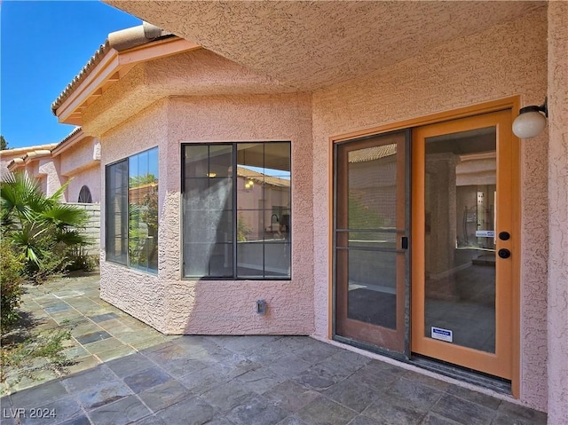 entrance to property featuring a patio area