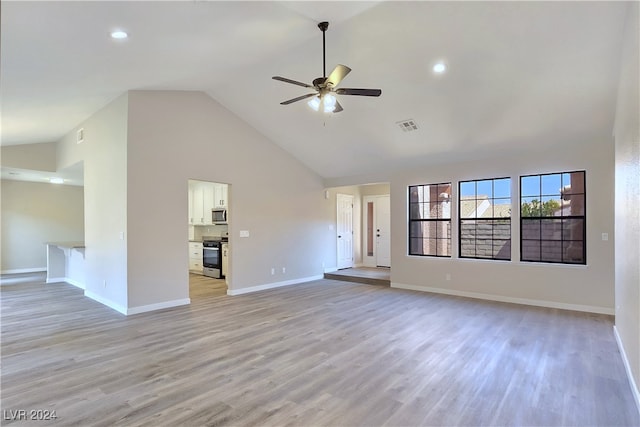 unfurnished living room featuring high vaulted ceiling, light hardwood / wood-style floors, and ceiling fan