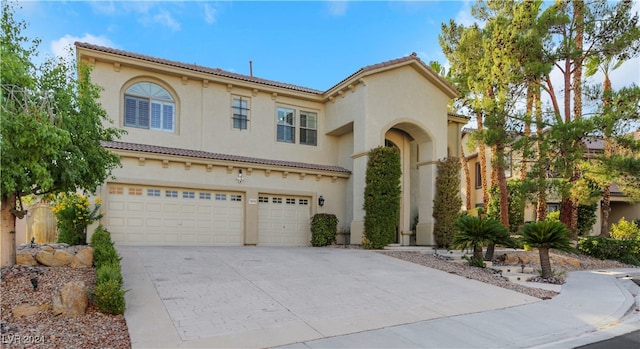 mediterranean / spanish-style home with a garage