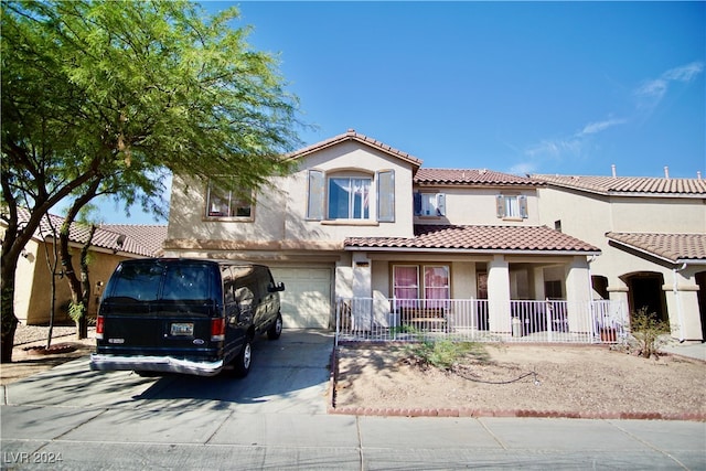 mediterranean / spanish house with a garage