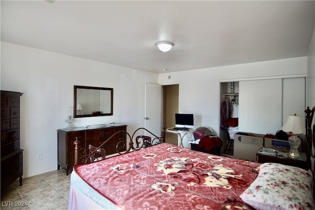 tiled bedroom with a closet