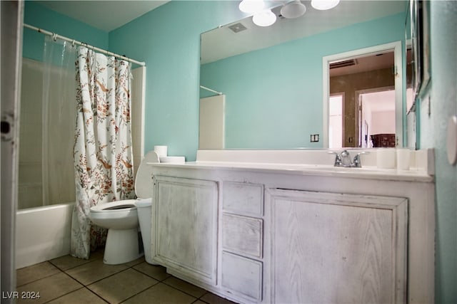 full bathroom with tile patterned floors, shower / bath combination with curtain, vanity, and toilet