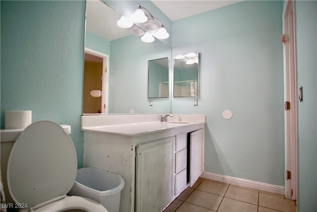 bathroom with tile patterned flooring, vanity, and toilet