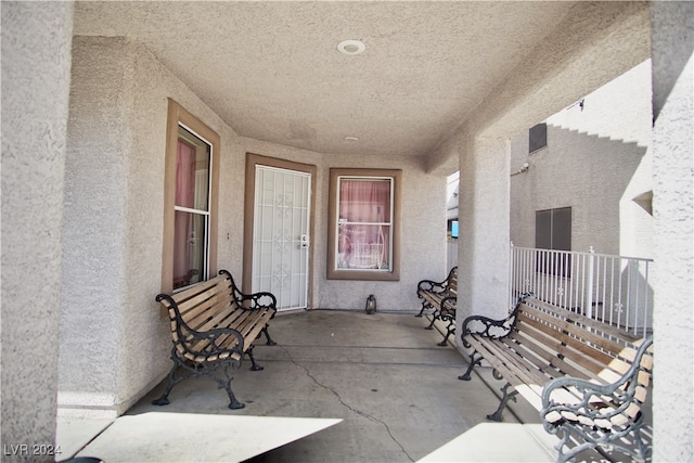 property entrance with a balcony and a patio