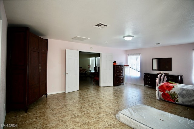 tiled bedroom featuring a textured ceiling