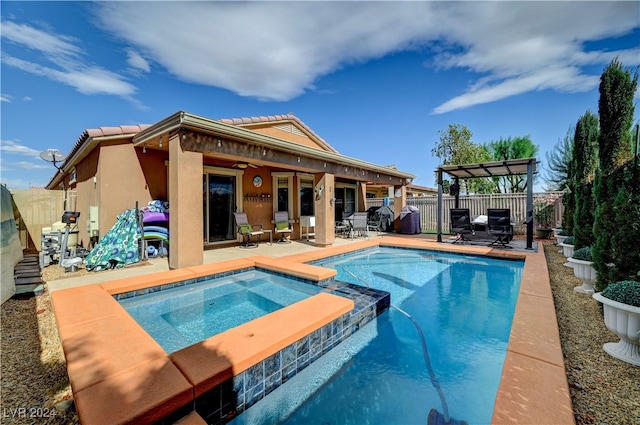 view of swimming pool with a patio area and an in ground hot tub