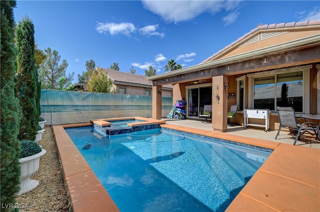 view of pool with an in ground hot tub and a patio area