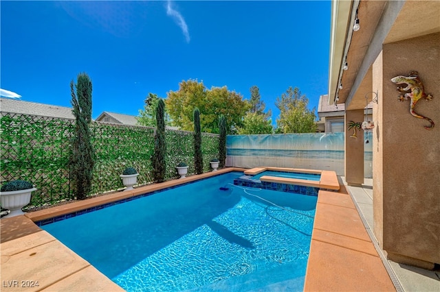 view of swimming pool with an in ground hot tub