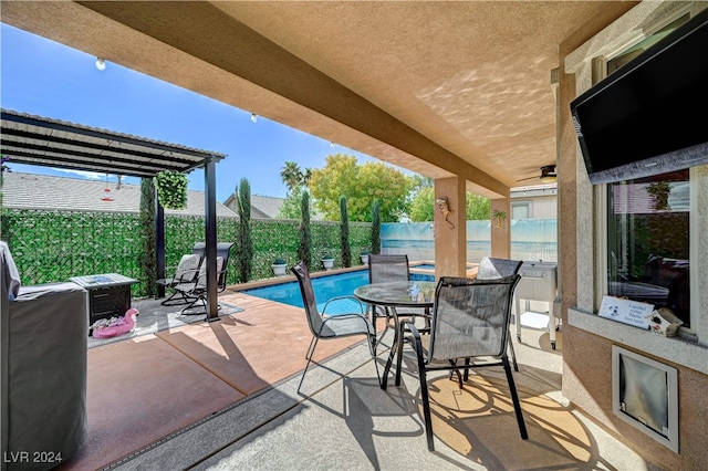 view of patio with a fenced in pool and ceiling fan