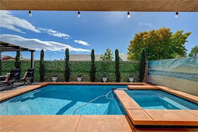 view of swimming pool featuring an in ground hot tub